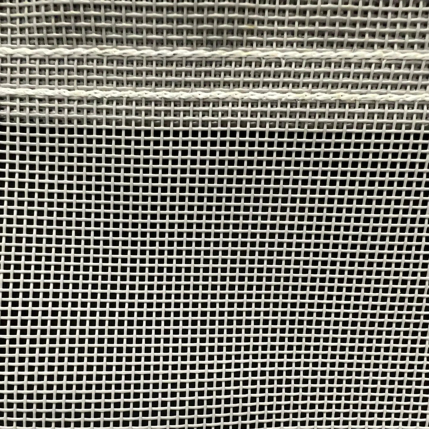 Gray 16' x 20' vinyl mesh tarp showcasing dense vinyl weave and stitched seams