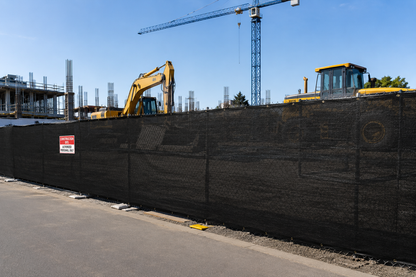 90% black 4' x 50' privacy fence screening a construction site