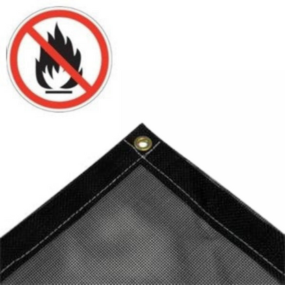 Close-up of black fire-retardant vinyl mesh tarp corner with brass grommet and reinforced hem; flame-resistant and breathable, ideal for safety, shade, or ventilation.