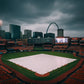 Baseball stadium with a cloudy sky and city skyline in the background