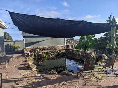 Black 20' x 20' 86% super shade mesh tarp used for outdoor sunshade installation