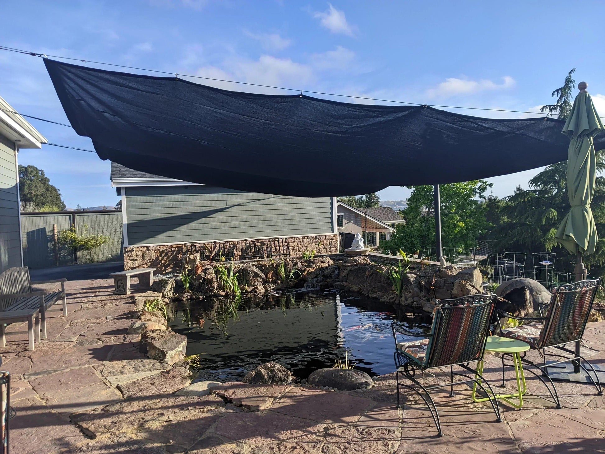 Black 8' x 10' 86% super shade mesh tarp used as a sun blocking canopy