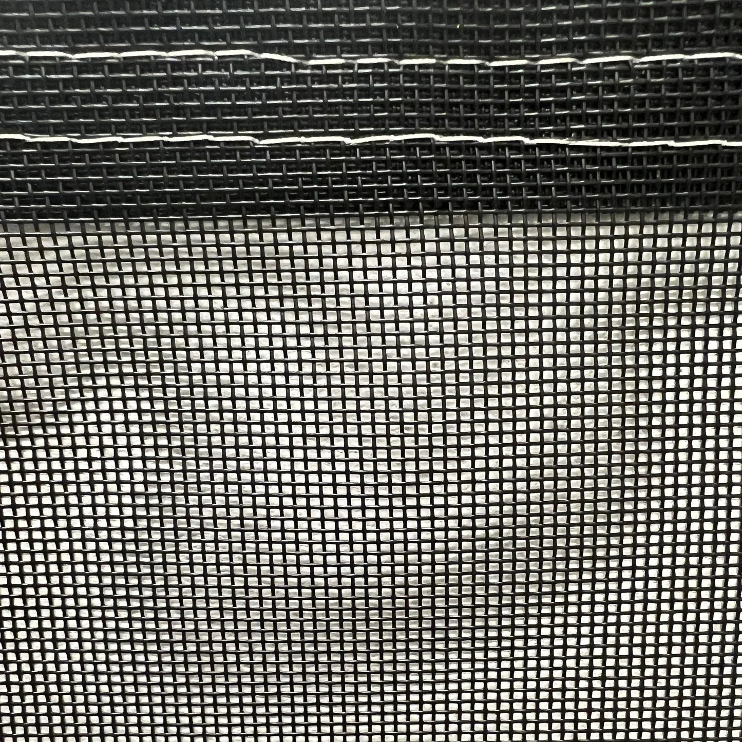 Black 5' x 7' vinyl mesh tarp featuring woven mesh fabric and durable edging