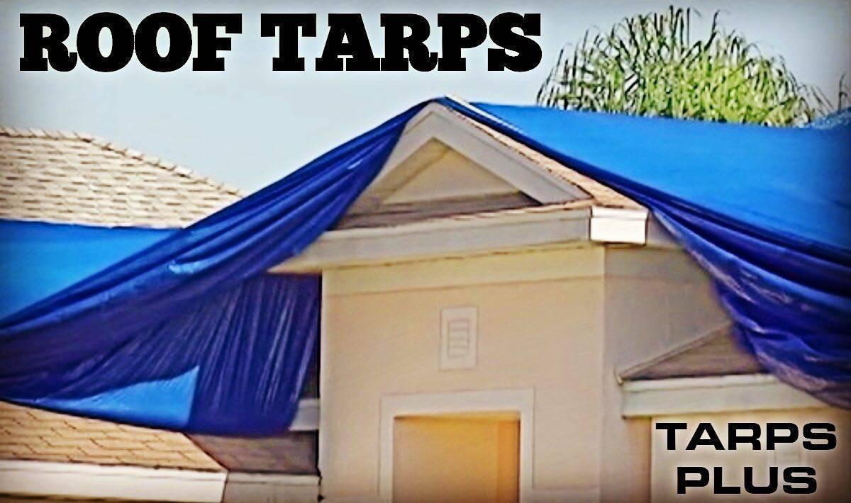 Blue hurricane tarp used for building recovery protection following storm damage