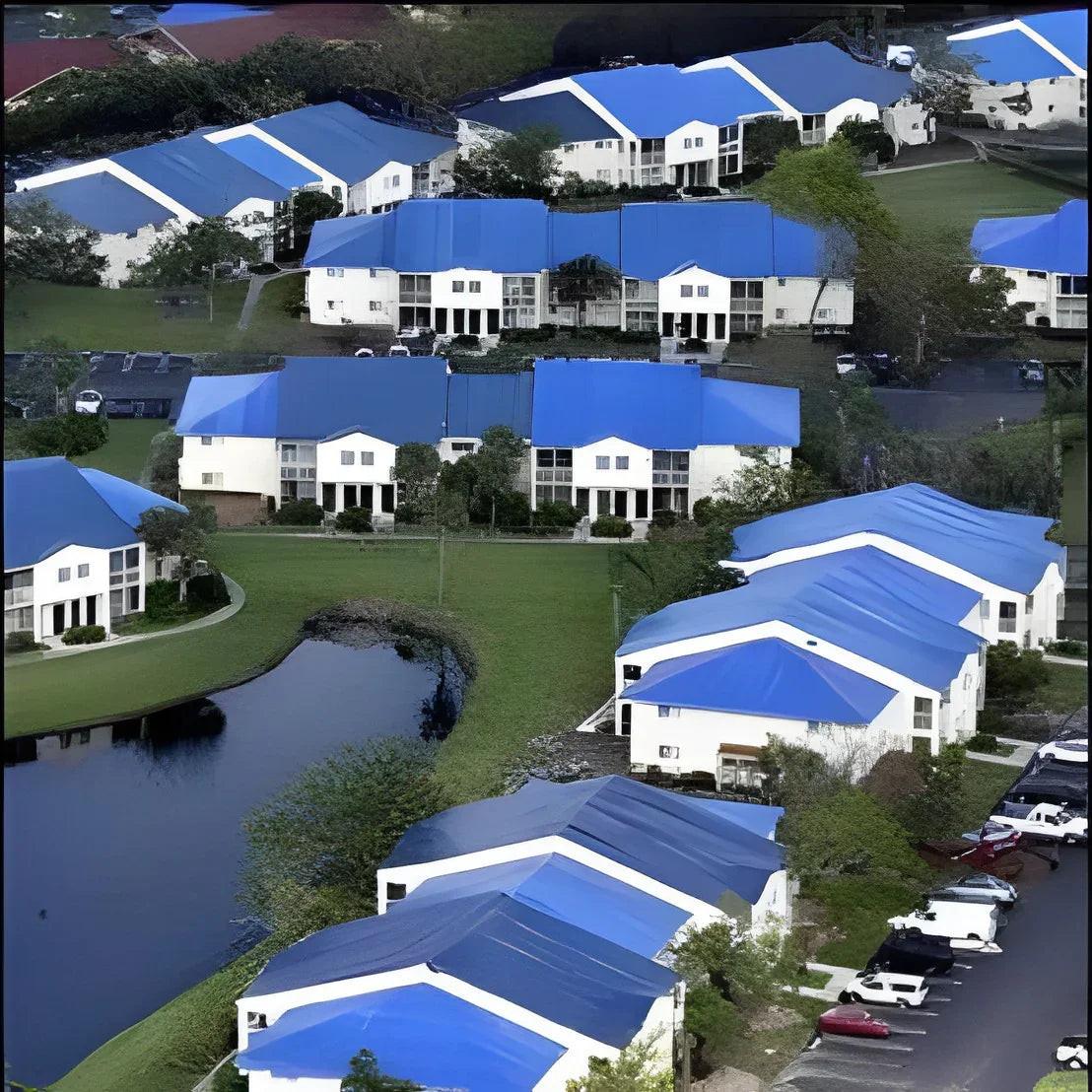 Blue hurricane tarp providing large scale relief covering for multiple temporary structures and shelters