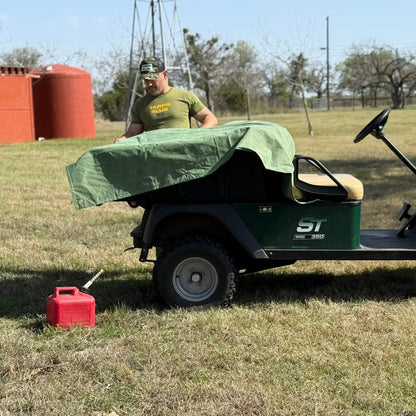 Green 8' x 10' canvas tarp covering outdoor utility equipment for protection