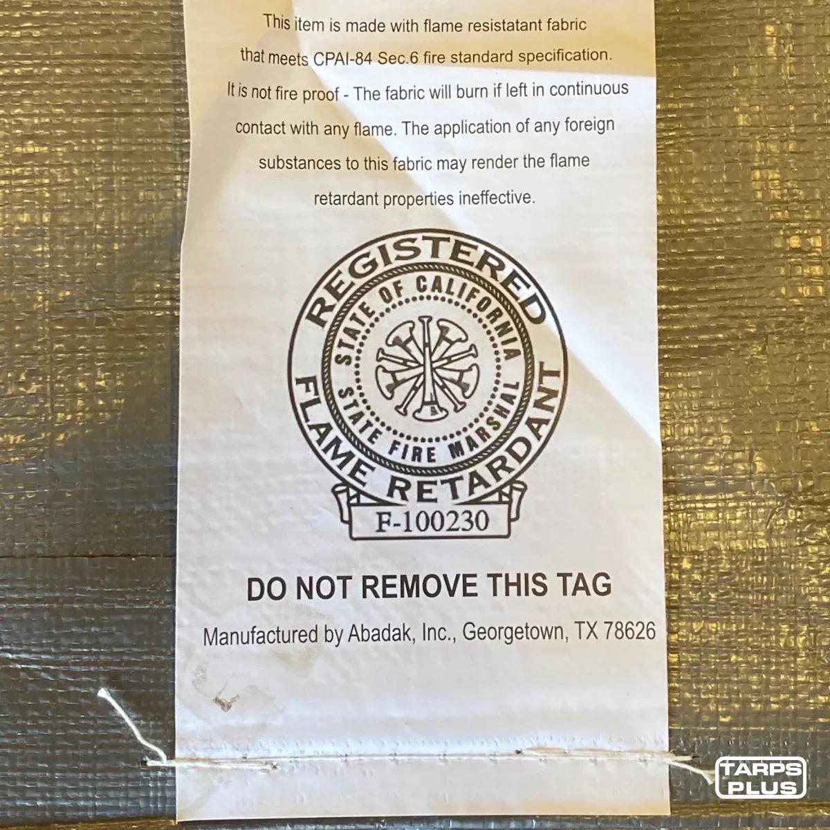 Silver 10' x 20' tarp cover displaying quality verification label detail