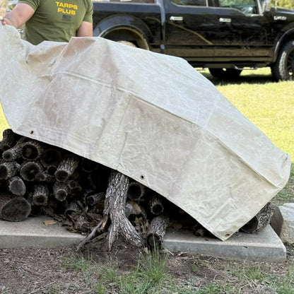 White 5' x 7' canvas tarp covering stacked firewood for outdoor weather protection