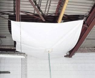 White drain tarp 5' x 5' functioning as a ceiling water diversion panel