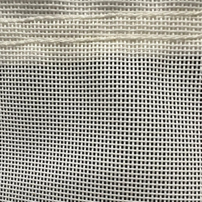 White 30' x 40' vinyl mesh tarp displaying durable grid mesh and secure border binding